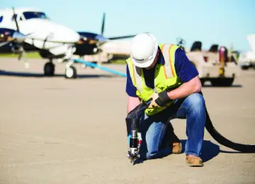 airport runway with equipment near planes.